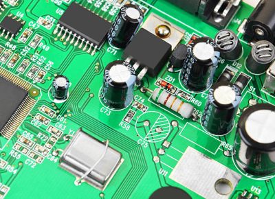 Green printed computer motherboard with microcircuit, close-up